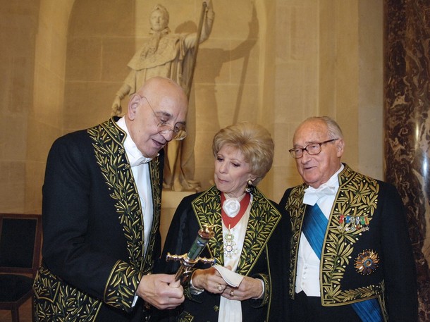 ''French writer and new member of the Academie Francaise Max Gallo (L) shows his sword (traditionnaly given to members of the academy) to Academie members and French writers Helene Carrere d'Encausse (C) and Alain Decaux 31 January 2008 during his reception ceremony at the Academie Francaise in Paris.''