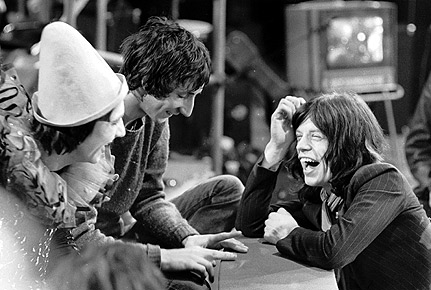 Mick Jagger chats with The Who drummer Keith Moon (1947-1978, left) and songwriter/guitarist Pete Townshend (centre), during the filming of The Rolling Stones' Rock'n'Roll Circus at Internel Studios in Stonebridge Park, Wembley.