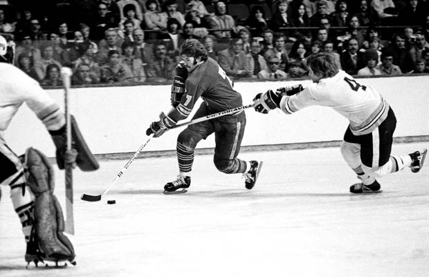 BOSTON, MA. - 1970's: Rick Martin #7 of the Buffalo Sabres skates past Bobby Orr #4 of the Boston Bruins at the Boston 