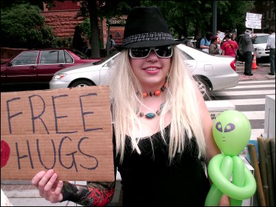 Scientology demo D.C. ''Posing with a "Free Hugs" sign and our little friend... ''