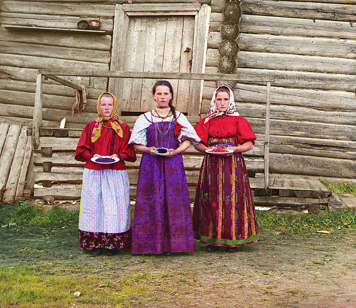 ---Young Russian peasant women in front of traditional wooden house, in a rural area along the Sheksna River near the small town of Kirillov. Early color photograph from Russia, created by Sergei Mikhailovich Prokudin-Gorskii as part of his work to document the Russian Empire from 1909 to 1915.---source: WIKI